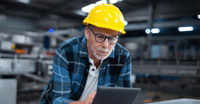 Old guy with tablet in factory